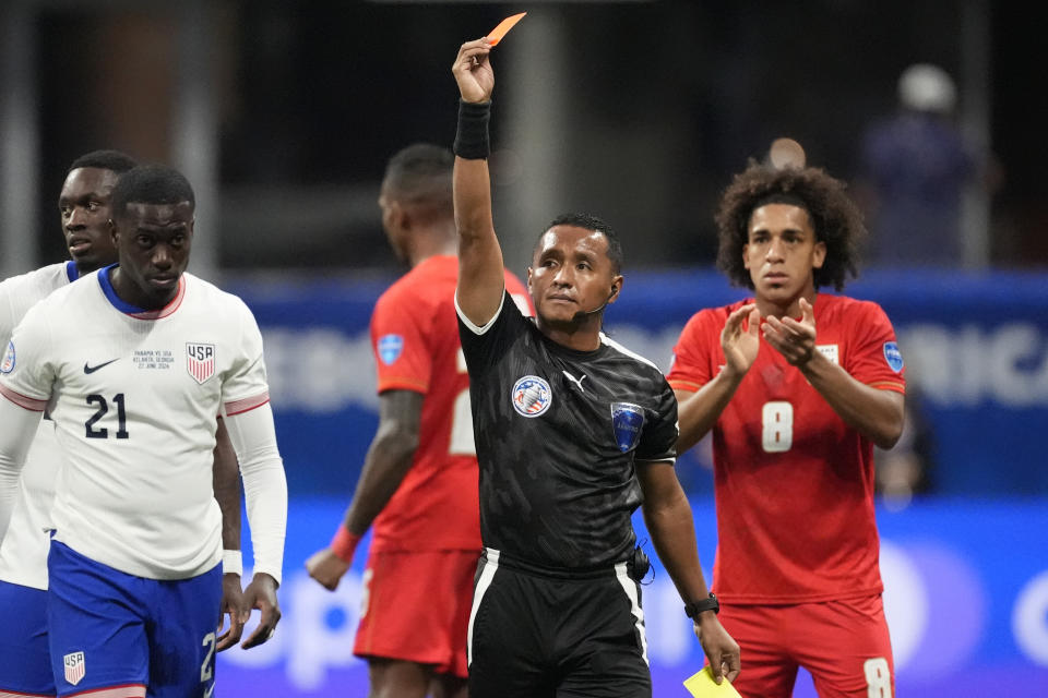 Referee Ivan Barton ejects Tim Weah of the United States, left, during a Copa America Group C soccer match against Panama in Atlanta, Thursday, June 27, 2024. (AP Photo/Mike Stewart)