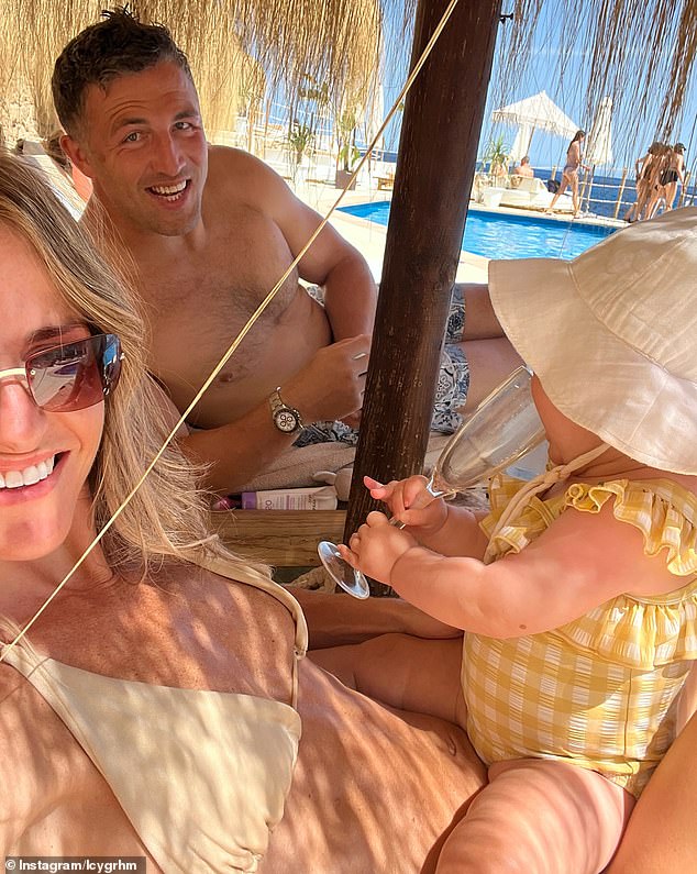 The couple also posed for a family photo with their little girl while relaxing under an umbrella on the beach.