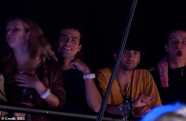 Moses (pictured right) was seen watching his dad's Glastonbury show on Saturday alongside his older sister Apple (left) and friends.