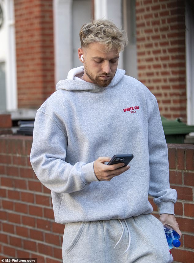 Leaving his house on Monday to head to the gym, tracksuit-clad Sam failed to crack a smile and was busy checking his phone as he walked to his workout.