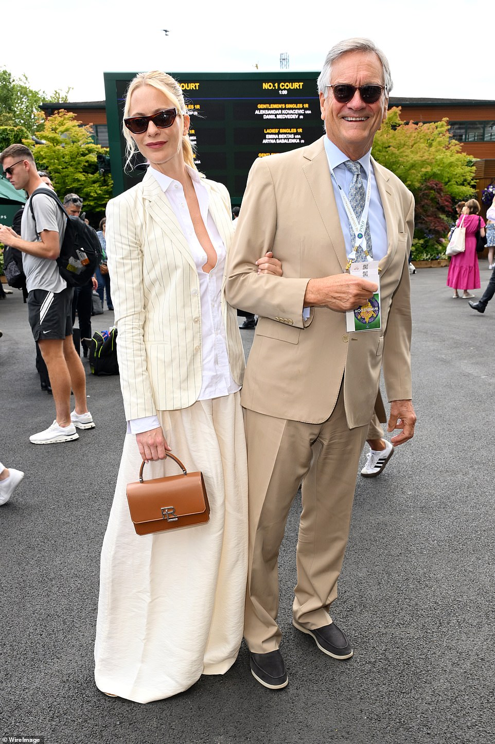 Poppy Delevingne looked effortlessly chic in an off-white suit as she attended a celebrity-studded event with her father Charles