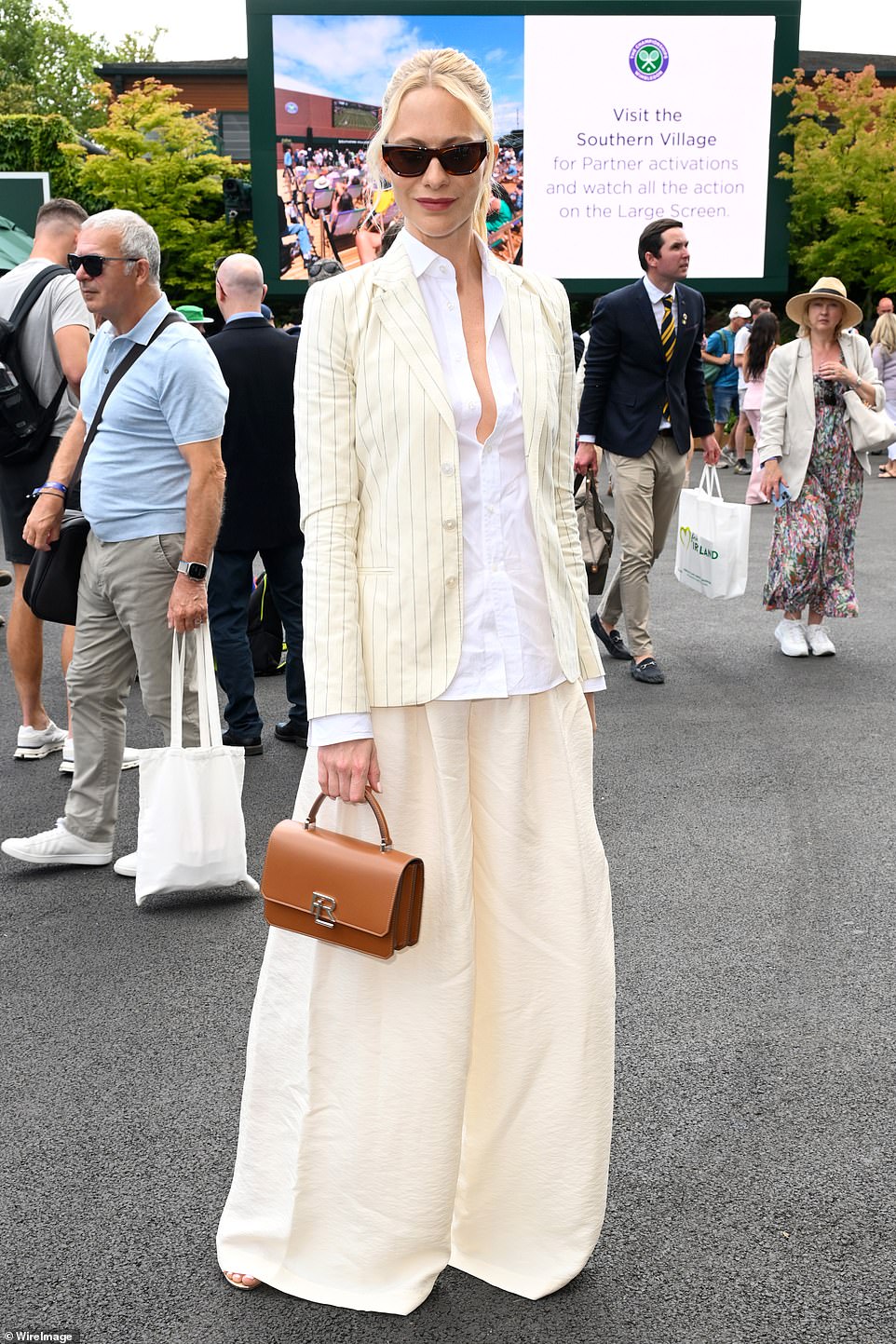 The socialite, 38, cut a glamorous figure in a fitted blazer and balloon pants, paired with a low-cut white shirt.