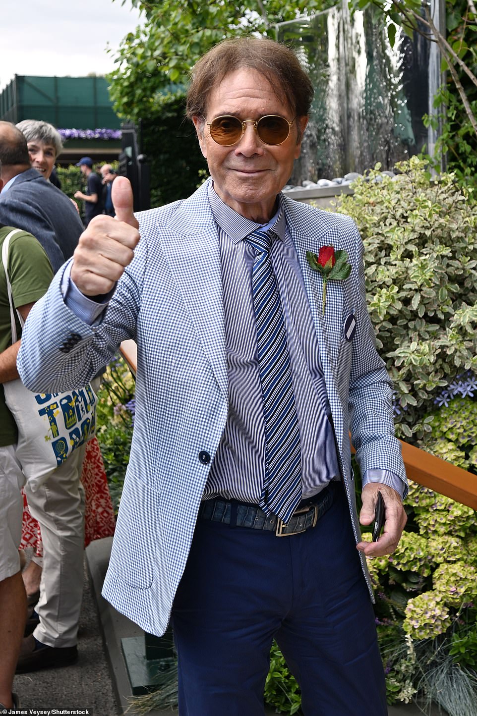 Also in attendance was Cliff Richard, who looked in high spirits as he held up a peace sign inside the courtyard.