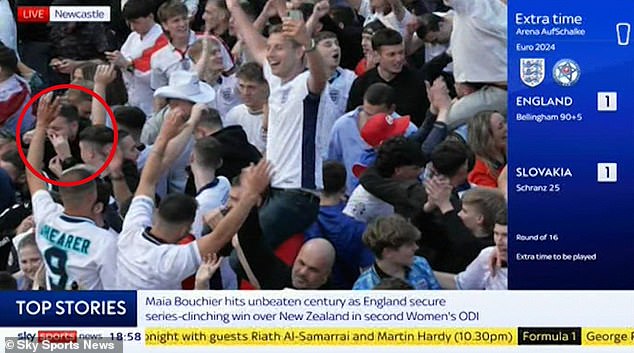 As the ecstatic crowd danced and began to play Neil Diamond's Sweet Caroline, the fan (circled), dressed in black, appeared to inhale a mysterious substance.