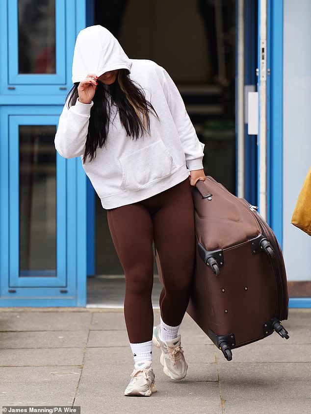 The former prison officer carried a large suitcase and hid her face when leaving the court