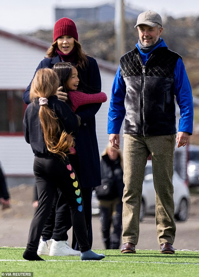 Royal mother of four was warmly hugged by local children during visit to Qeqertarsuaq in Greenland