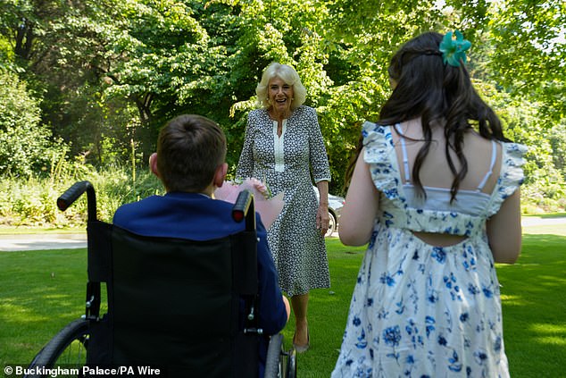 Tony presented the delighted Queen Camilla with a bouquet of flowers.