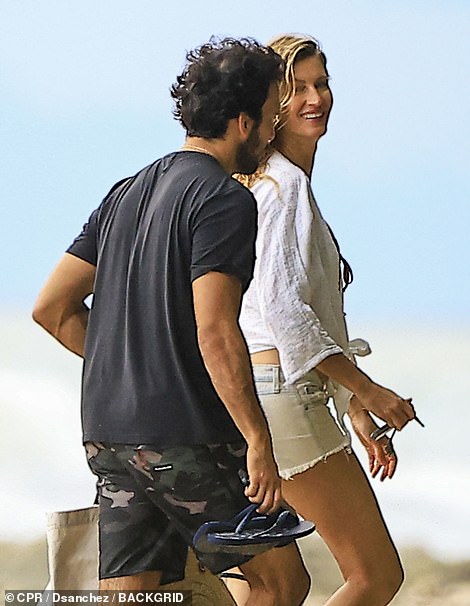 The couple looked in love as they headed to the beach together.