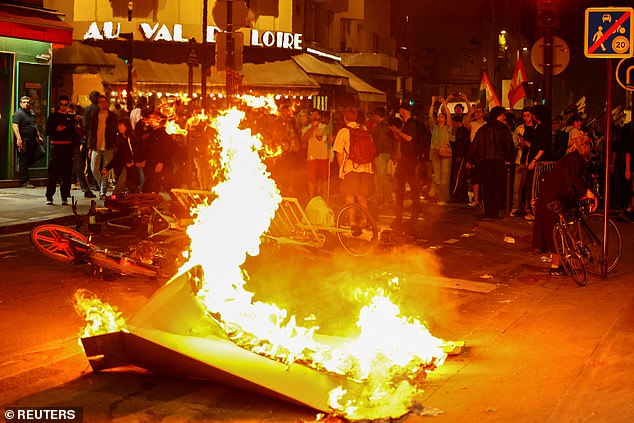 Barricade set on fire as protesters demonstrate against National Rally party