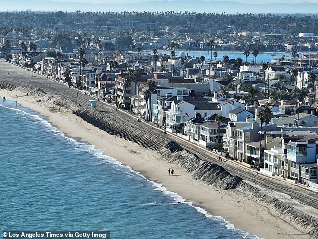 The move indicates that the insurance giant is in financial trouble as it is currently covering homes razed by the wildfires. Pictured is a row of houses in Long Beach, California.