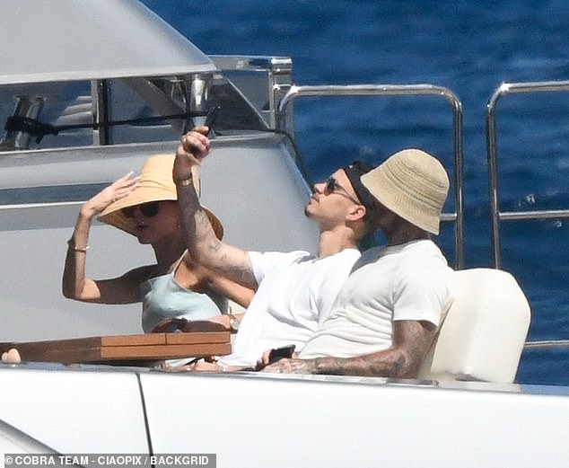 Romeo proved that three is not a crowd by taking a selfie with his father on the deck