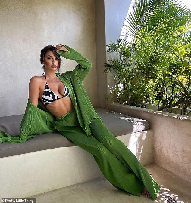 She showed off her toned abs in a zebra-print triangle bikini, which she paired with a forest green crepe co-ord.