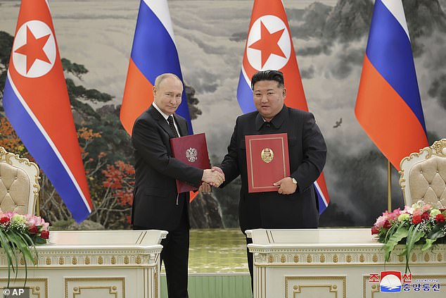 Kim Jong Un, right, and Russian President Vladimir Putin shake hands after signing a comprehensive strategic partnership in Pyongyang, North Korea, Wednesday, June 19, 2024.