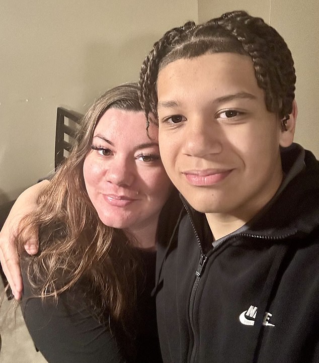 Ms Hampton, pictured with her son Tyrik Jones, 15, was originally told the coil had simply fallen off.