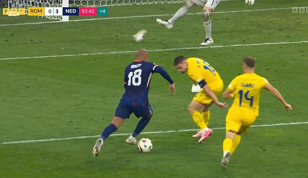 Romanian goalkeeper Florian Nita (top of screen) was forced to kick a trainer when Malen shot.