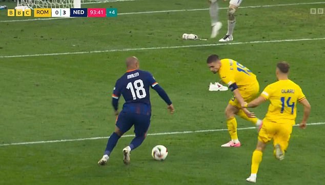 The boots were placed precariously inside Romania's penalty area when Donyell Malen cut inside.