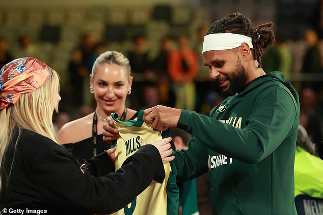 After the basketball game, Tones was seen handing a jersey to one of the players on the court.