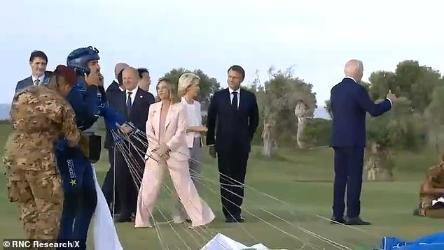 Biden appeared to distance himself from other world leaders at the G7 summit last month (pictured). The White House has insisted he was moving to greet the skydivers who were photographed off-screen, but his movements were unusual.