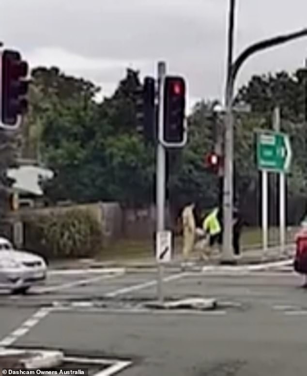 A worker has been praised for stopping the driver of the blue Mazda after he was seen casually walking off the road and away from the scene of the accident.