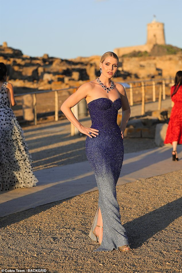 Kitty Spencer was photographed posing with her hands on her hips in an embellished strapless blue dress as she stood in the sunshine.