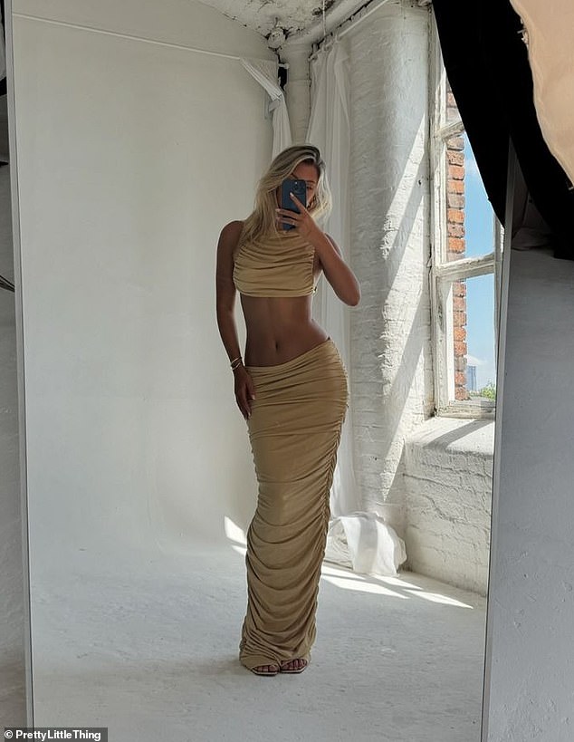 The model flaunted her toned midriff as she then donned a stunning gold ruched crop top and matching low-rise maxi skirt.