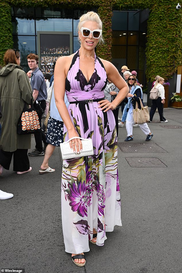 The 49-year-old Ted Lasso star looked gorgeous in a purple dress with a plunging neckline, bold floral print and halterneck style that flaunted her toned arms.