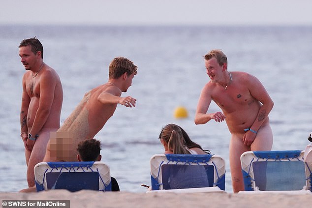 Tourists show off their behinds on the beach in Spain