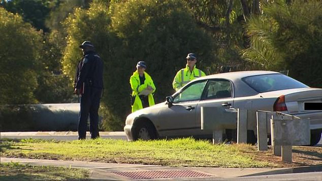 A 22-year-old woman had her license revoked and was charged with reckless driving (pictured: the driver's car at the scene of the accident)