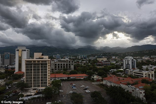 Storm clouds gather over the mountains as people make last-minute preparations for the arrival of Hurricane Beryl on July 3, 2024 in Kingston, Jamaica.