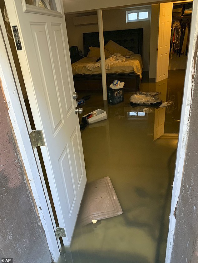 In 2019, sewage flooded around 300 homes in Jamaica, Queens, destroying furniture, electronics and other belongings as putrid waste spread throughout the area. Pictured: Sewage backup that flooded Cynthia McKenzie's home in Jamaica, Queens, in November 2019