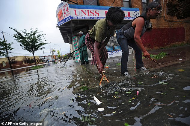 Approximately 40 million people live in areas with combined sewer systems, so it is essential to take steps to mitigate the risk of overflow. Pictured: Coney Island residents attempt to unclog a sewer grate in 2011