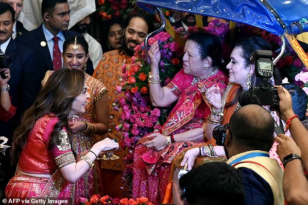 Nita Ambani, 60, greets guests during the traditional wedding ritual ahead of her son and Radhika's nuptials next week.