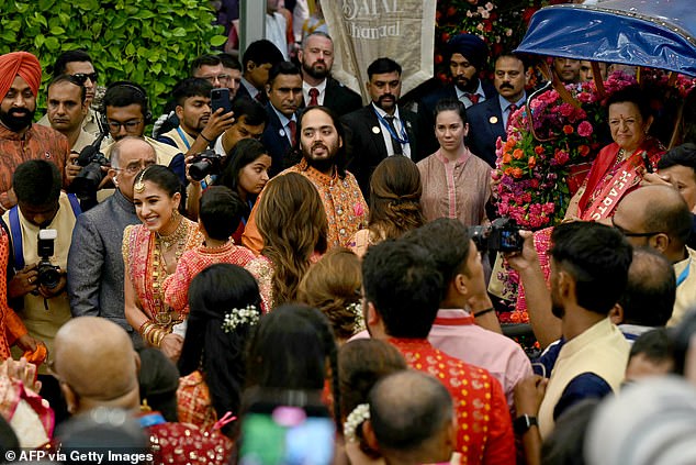 Anant and Radhika (centre) wore orange, which has a special significance in Hindu culture.