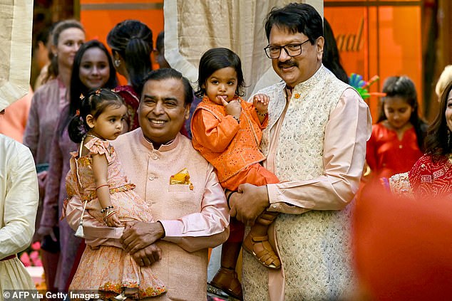 Anant's father Mukesh Ambani (left), 67, the billionaire chairman of Reliance Industries Limited, is pictured with industrialist Ajay Piramal (right) and their respective grandchildren.