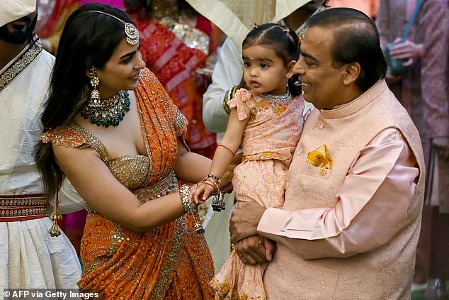 Mukesh is pictured with his daughter, Isha Ambani (left) and granddaughter at the event on Wednesday.