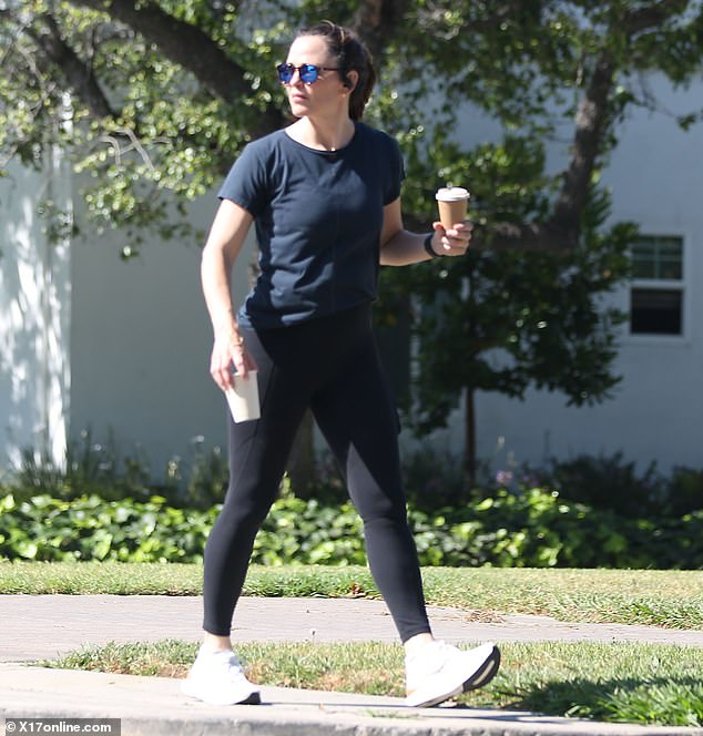 The mother of three wore a navy blue crew-neck, short-sleeved shirt with her sporty look, completing it with white sneakers.