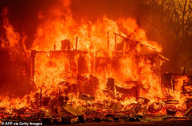 Flames engulf a home during the Thompson Fire in Oroville, California, on July 2, 2024.