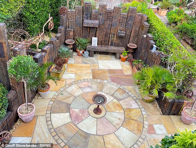 Geoff's stunning terrace garden. He recommends covering the pots with a layer of gravel to retain moisture and keep out insects.