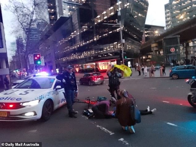 Passersby and police helped the woman while waiting for paramedics to arrive.