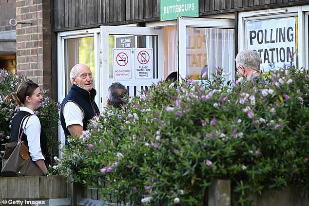 He wore a navy blue vest and white T-shirt as he queued to cast his ballot early Thursday morning.