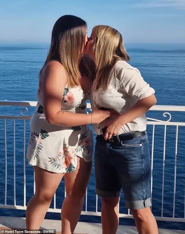 After popping the question, the couple shared a romantic kiss by the ocean.