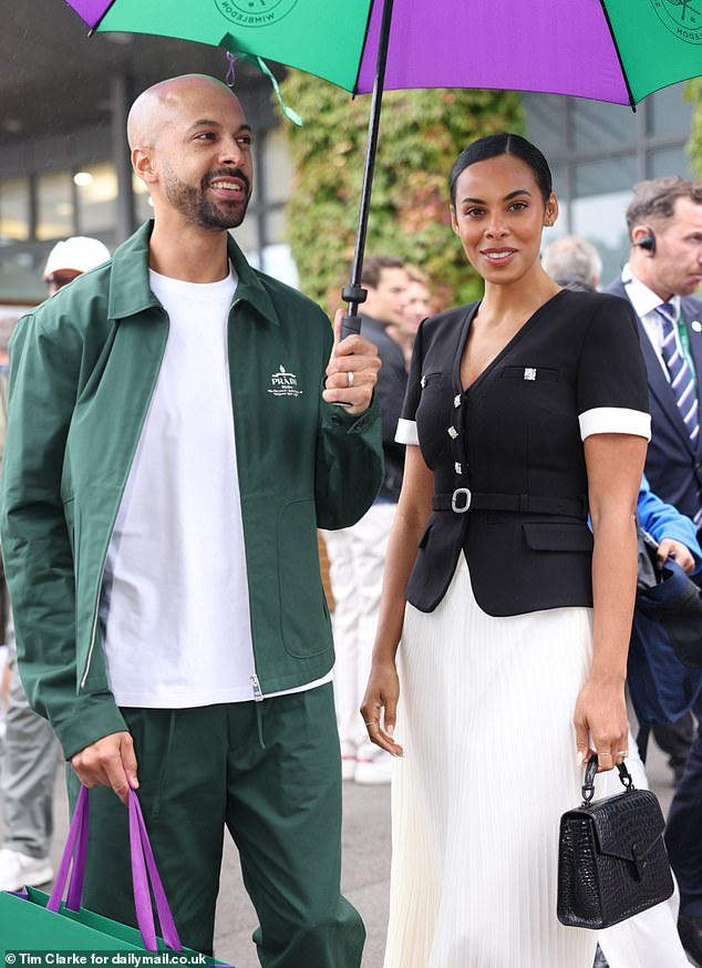 The couple didn't let the weather ruin their day at the All England Lawn Tennis and Croquet Club in southwest London.