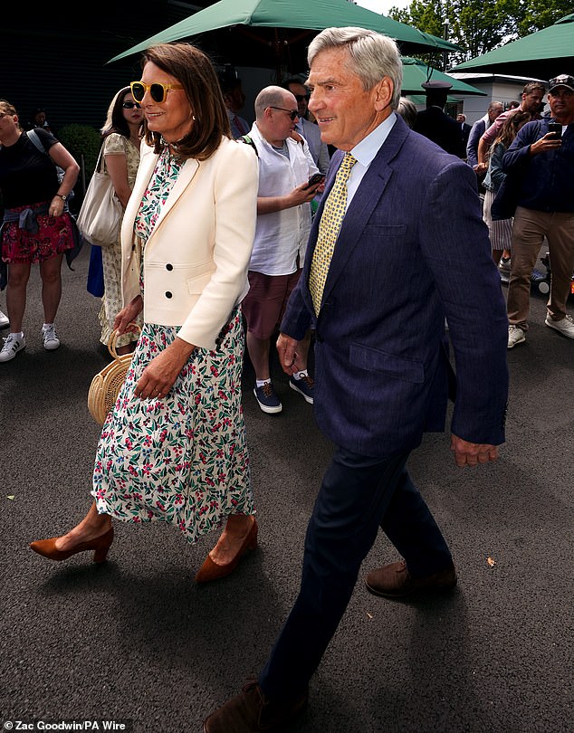 Ready for the cooler British weather, she paired the stunning dress with a white blazer, featuring structured shoulders.