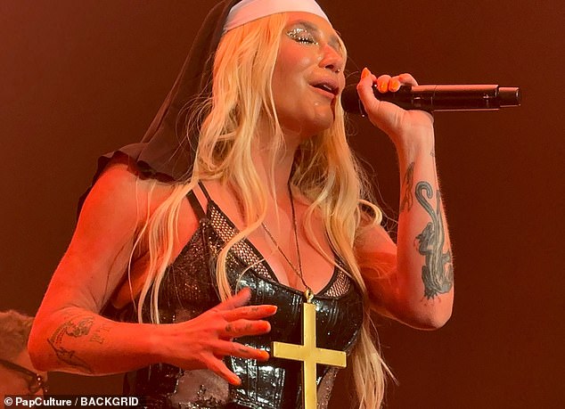 The star also changed outfits several times and proceeded to dress as a nun by wearing a large necklace with a gold cross.