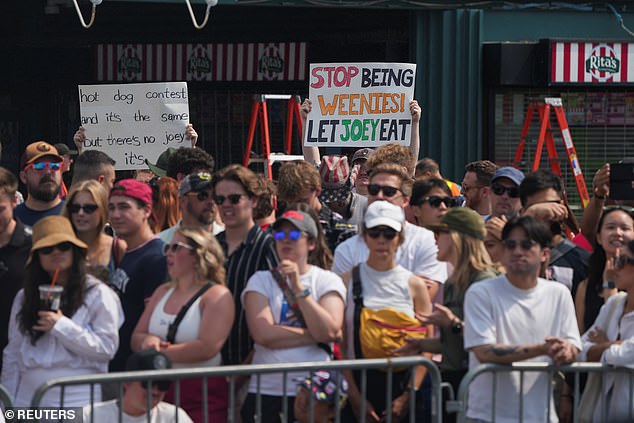 Fans held up cardboard signs to express their disapproval of Chestnut's exclusion this year in New York.