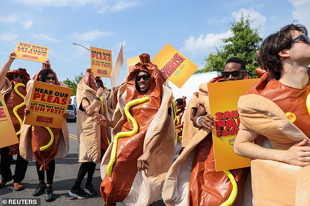 WHO LET THE DOGS OUT: People dressed up as hot dogs in a parking lot in Coney Island, New York