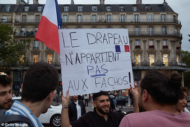 A man holds a sign that says 