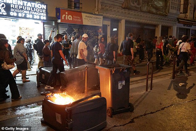 The containers were overturned and set alight, sending acrid smoke into the air.