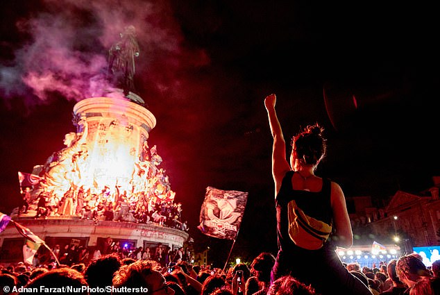 Protesters take part in an anti-RN demonstration following the announcement of the results of the first round of the French parliamentary elections at the Place de la Republique in Paris on June 30, 2024.