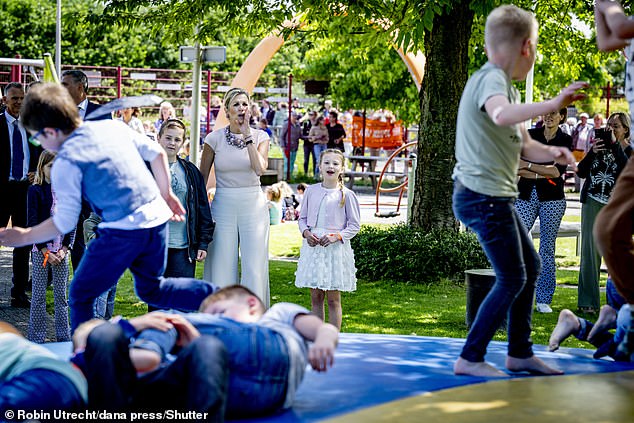 The mother of three cheered on the children as they took part in activities and games on the playground.